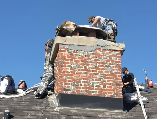 North Reading Chimney Sweep installing a custom chimney crown in North Reading, MA