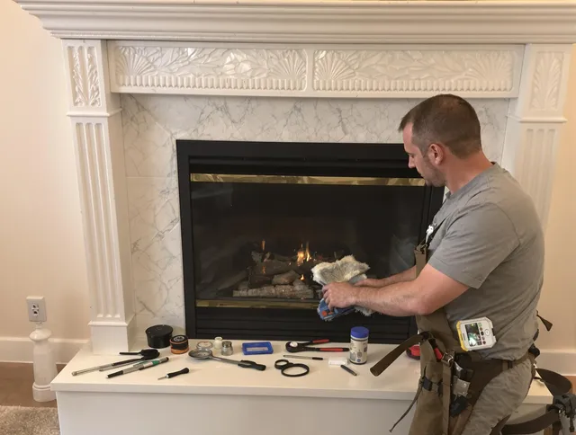 North Reading Chimney Sweep performing fireplace maintenance in North Reading, MA